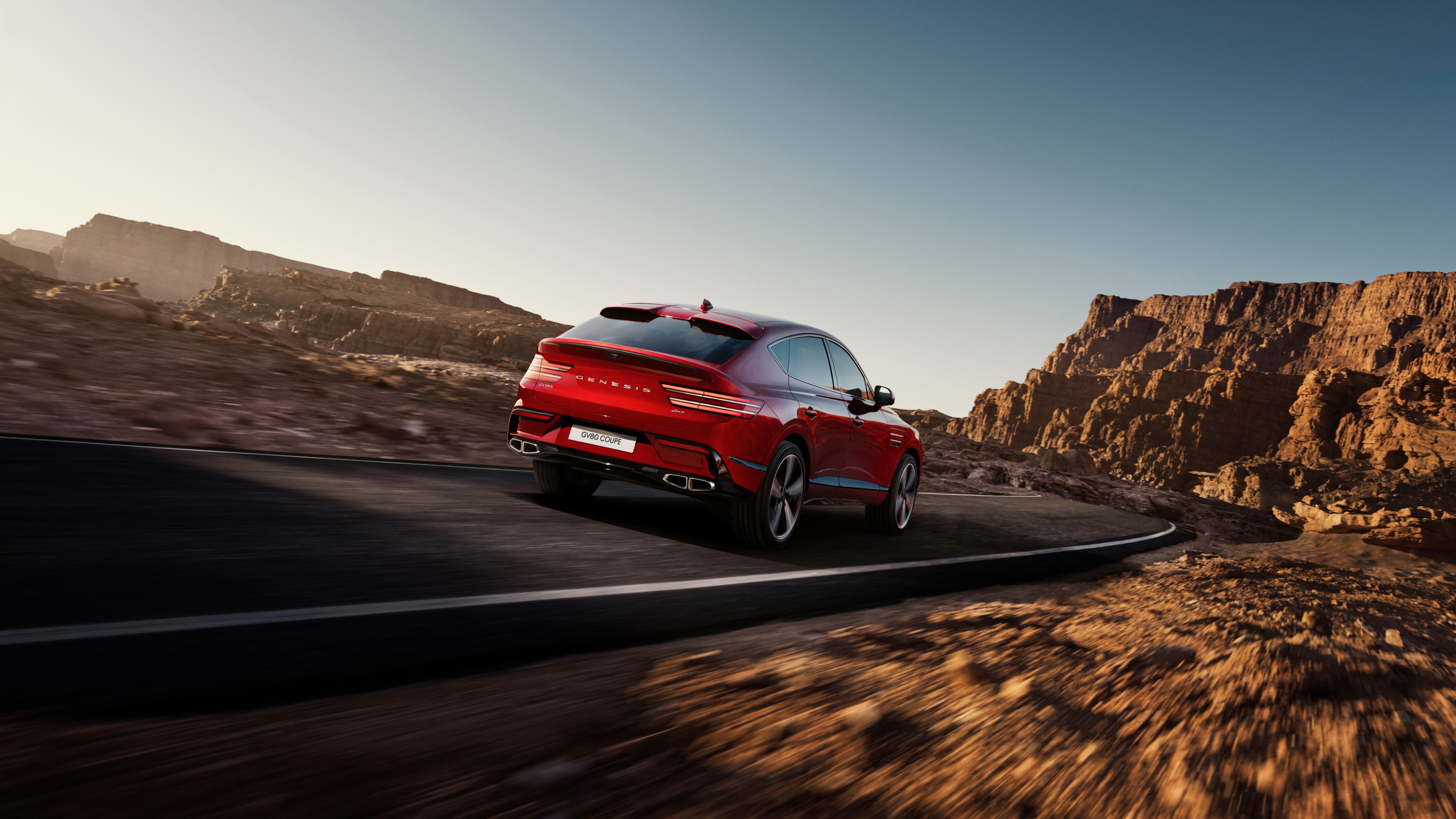 The rear of the Mauna Red GV80 Coupe as it drives.