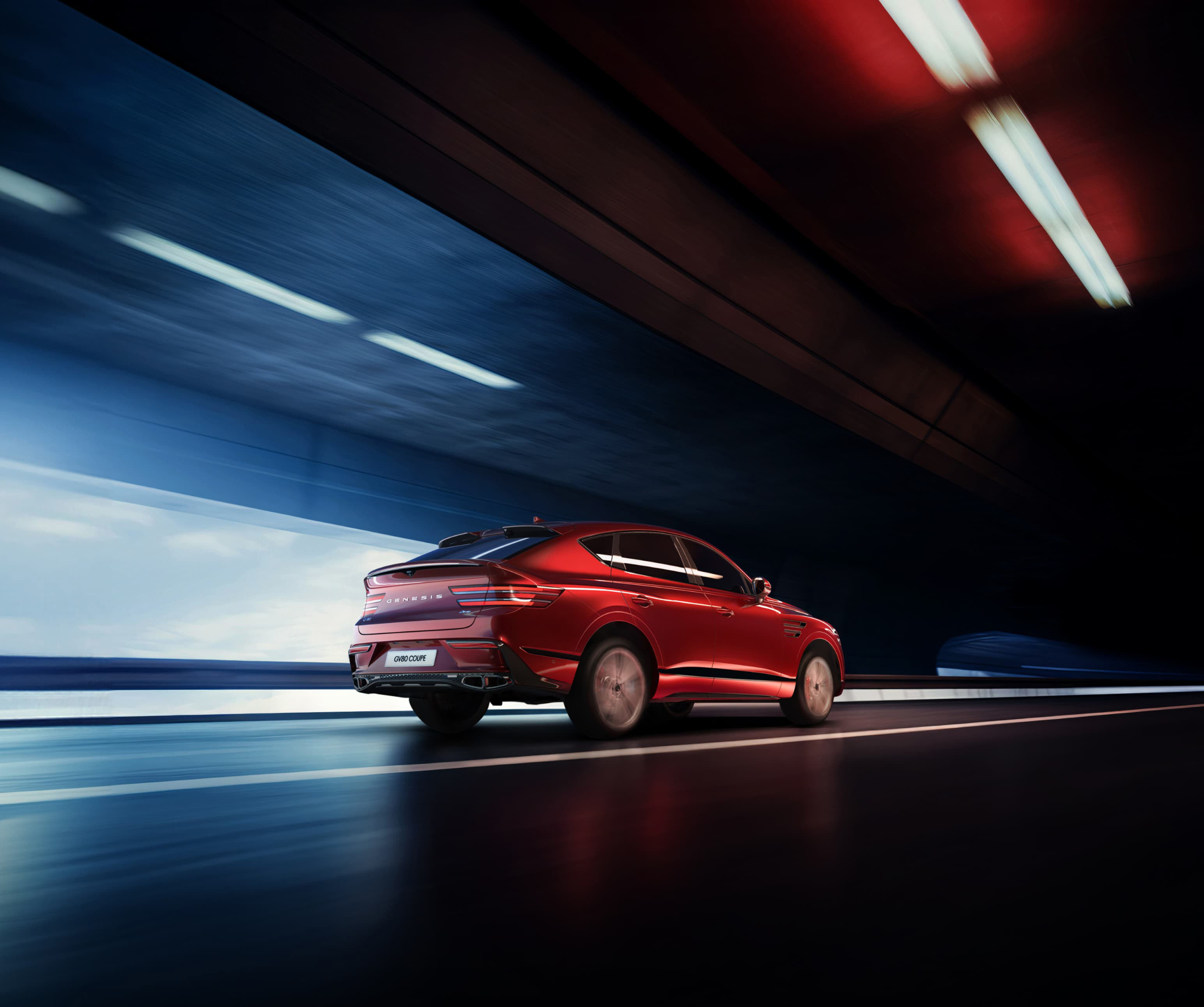 Mauna Red GV80 Coupe driving quickly through a tunnel.
