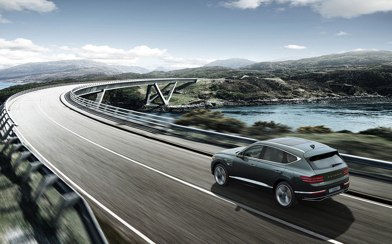Storr Green GV80 Coupe driving on the highway.