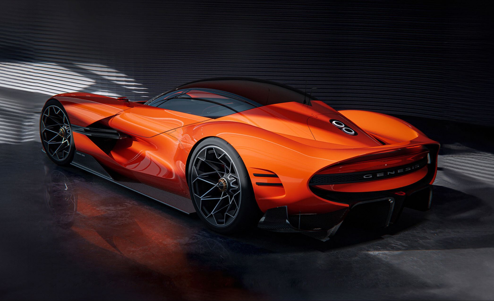 A slightly elevated view of the X Gran Berlinetta Concept's side profile, illuminated under lights as it stands in front of a panel wall.