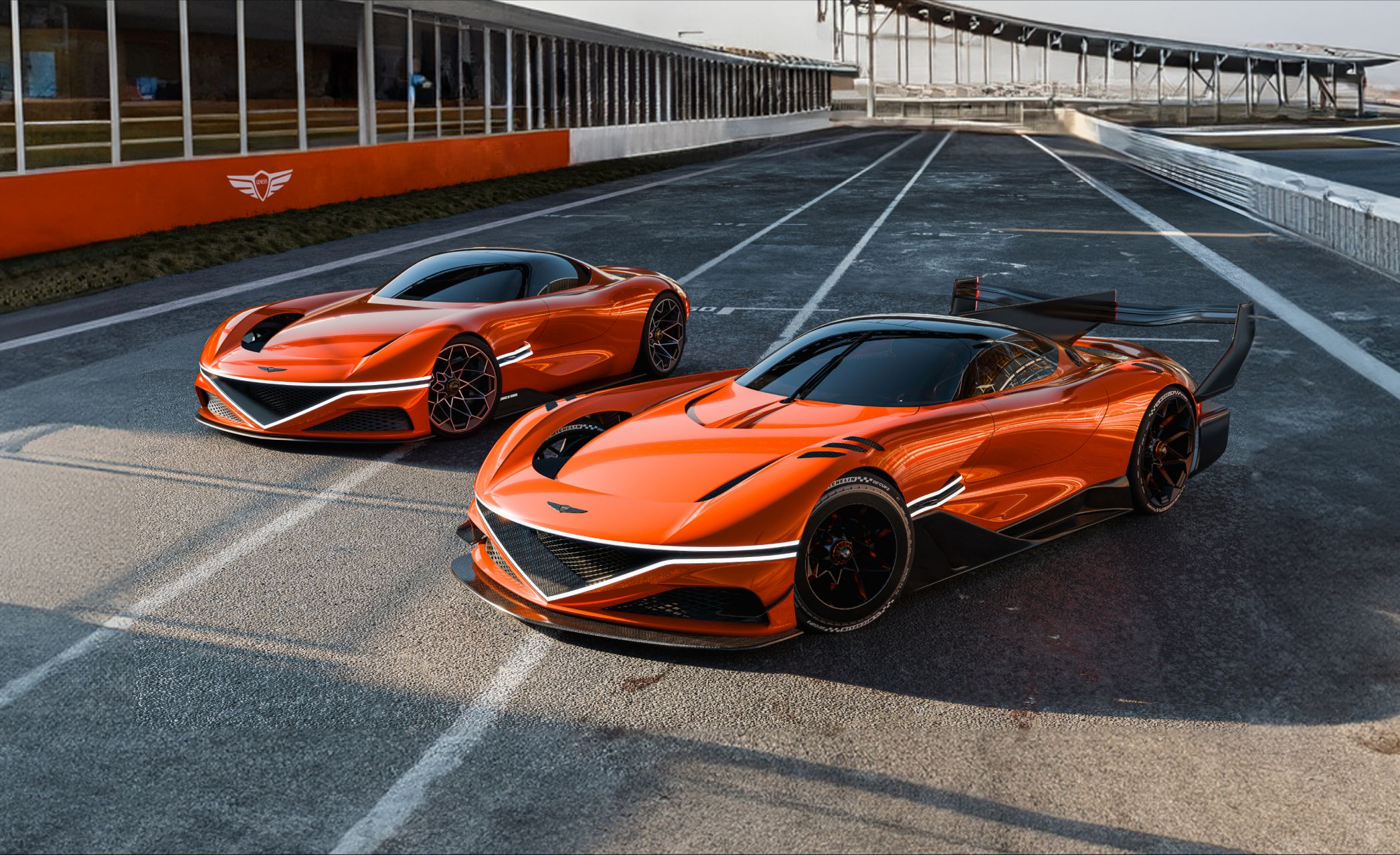 On a clear day at the outdoor racing circuit, two X Gran Berlinetta Concepts stand diagonally. One in the foreground appears larger, while the one in the background looks smaller. Twin front lamps shine bright white, and the natural light accentuates the metallic elegance of their bodies.