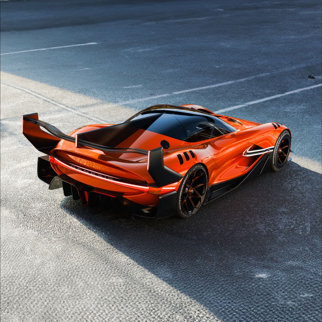 The X Gran Racer Concept is seen from an elevated diagonal view, highlighting the full expanse of the rear wing. Natural light reflects off the contoured body, accentuating the metallic finish of the vehicle.