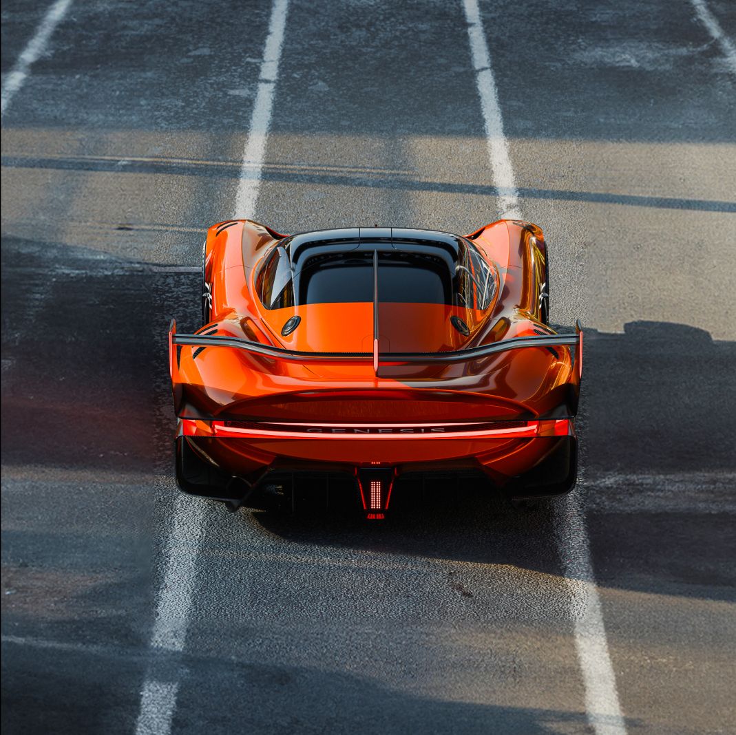 The X Gran Racer Concept is perfectly aligned with the circuit lines, gleaming under the light. The rear dual-line lamps shine bright white. From a front-down perspective, the curves of the body are mirrored by the elegantly contoured wing.