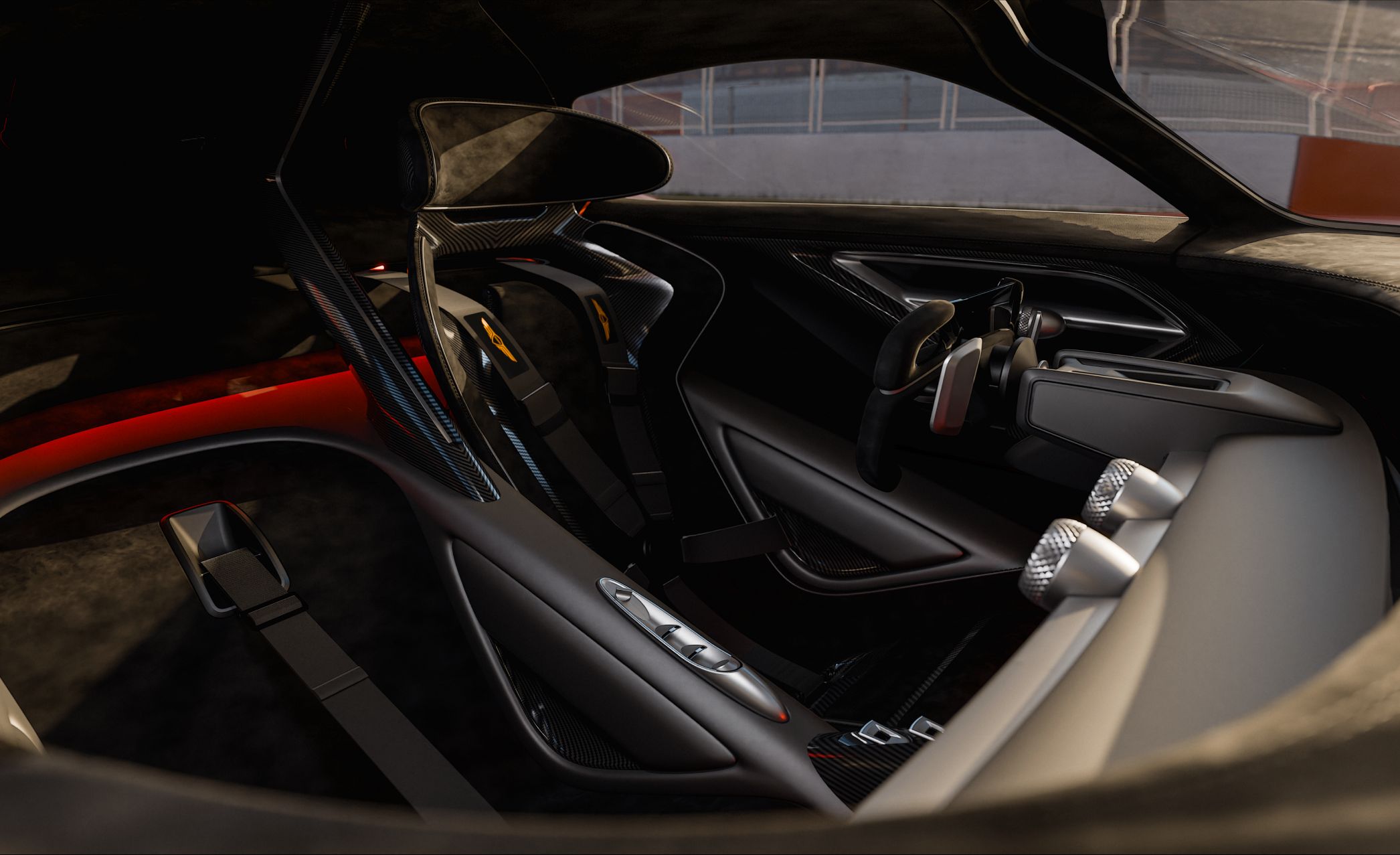An angled view of the X Gran Racer Concept’s interior reveals both the driver and passenger seats, reclined further back than in typical cars. The interior is elegantly crafted in black and silver tones.