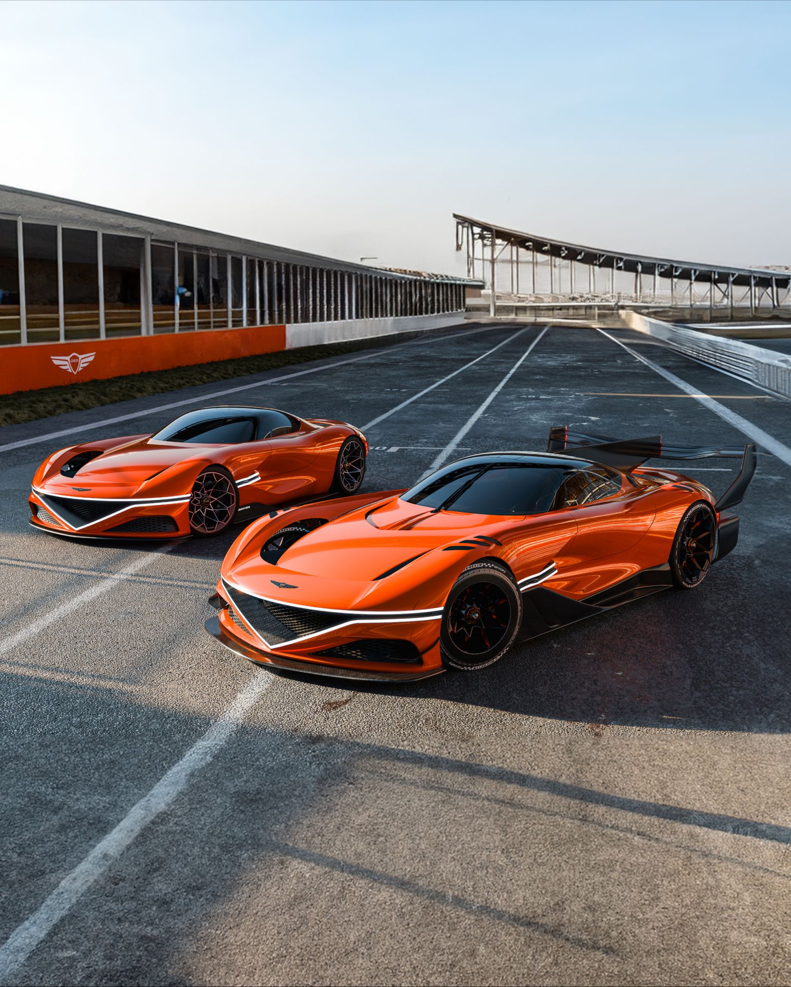 On a clear day at the outdoor racing circuit, two X Gran Berlinetta Concepts stand diagonally. One in the foreground appears larger, while the one in the background looks smaller. Twin front lamps shine bright white, and the natural light accentuates the metallic elegance of their bodies.