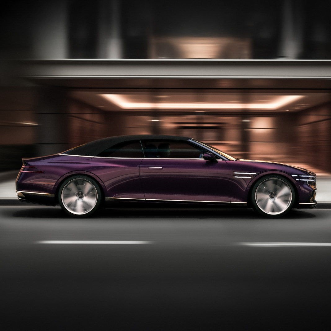 The Genesis X Gran Convertible is driving with its side visible.