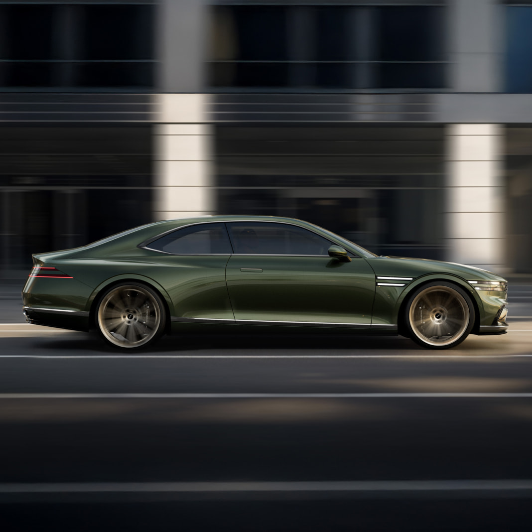 The Genesis X Gran Coupe is driving with its side visible.