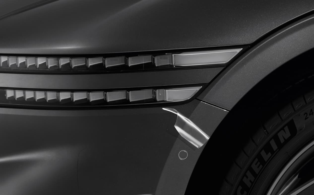 The Paint Protection Film rolled up at the bottom of the headlamp on Makalu Gray G90.