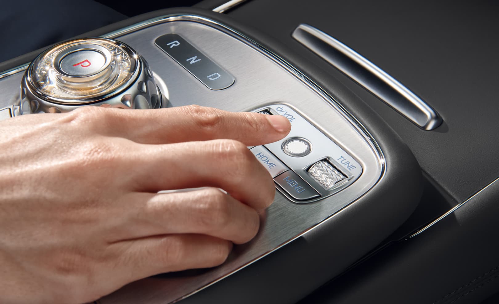 A hand uses the fingerprint scanner on the integrated controller.