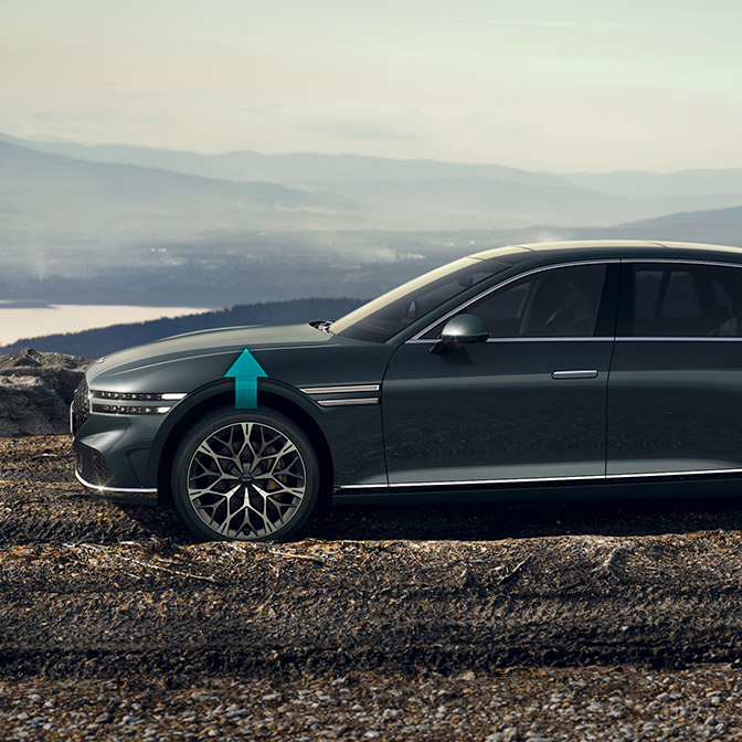 Hallasan Green G90 driving on a gravel road with upward arrows on its front wheels.