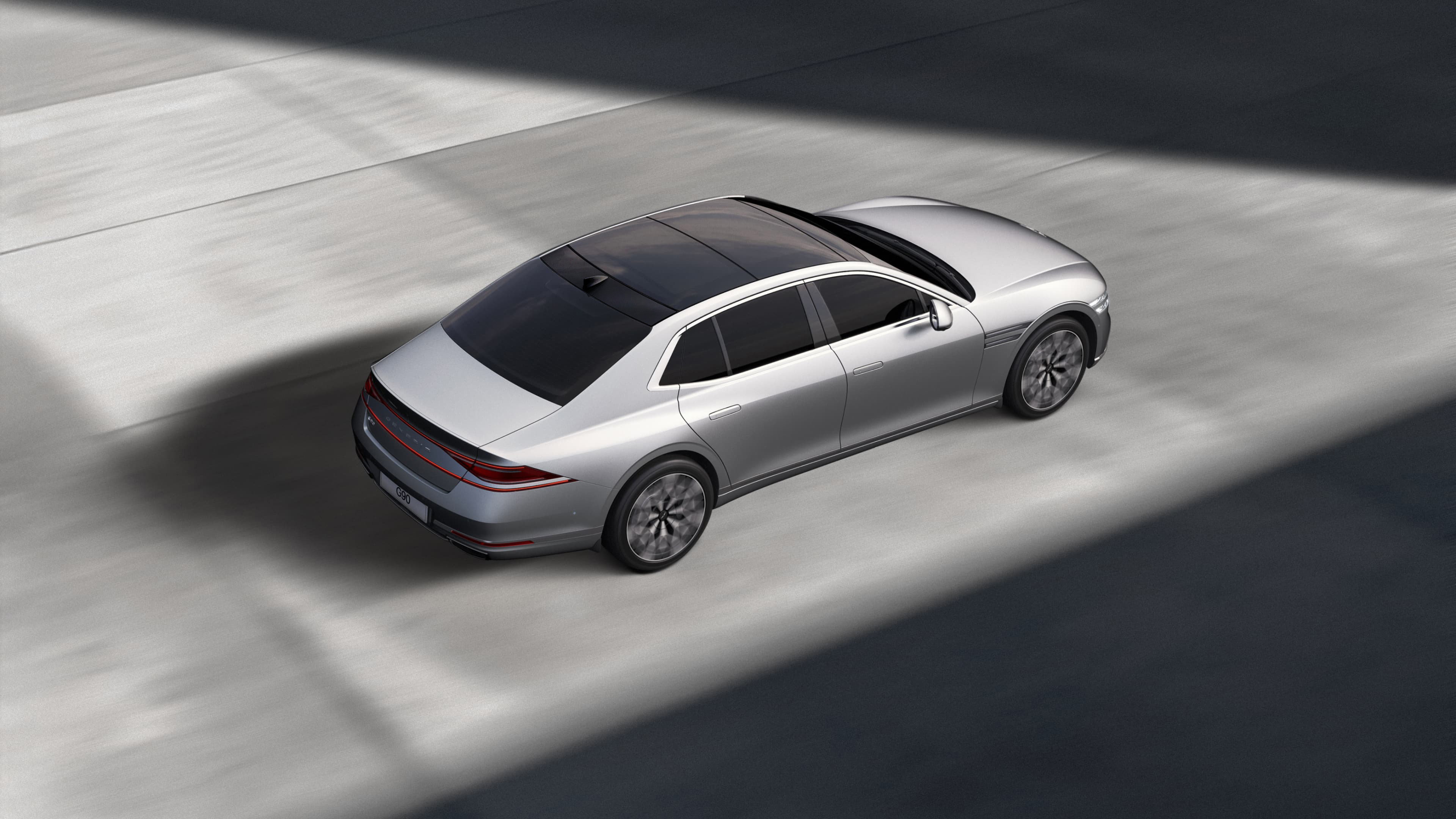 Savile Silver G90 is driving in a well-lit area, surrounded by shadows.