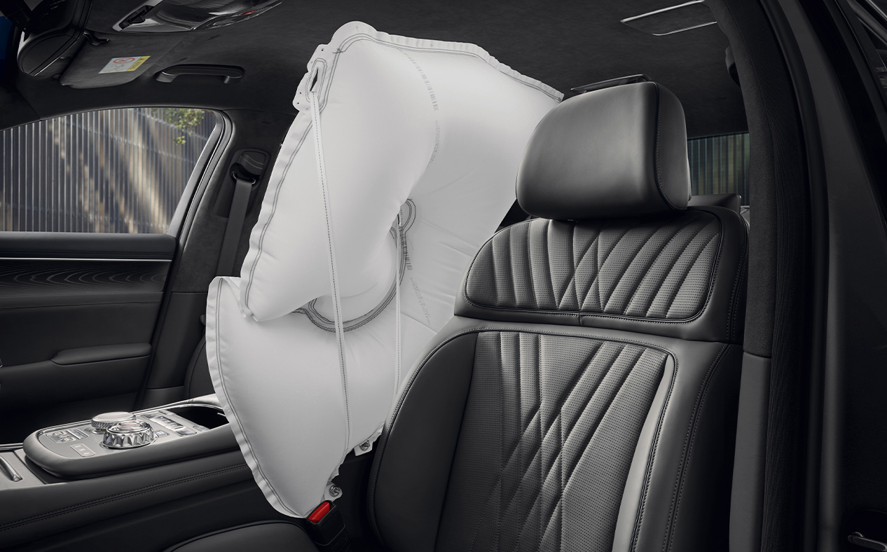 A white airbag is inflated between the driver and passenger seats in Modern Gray interior.
