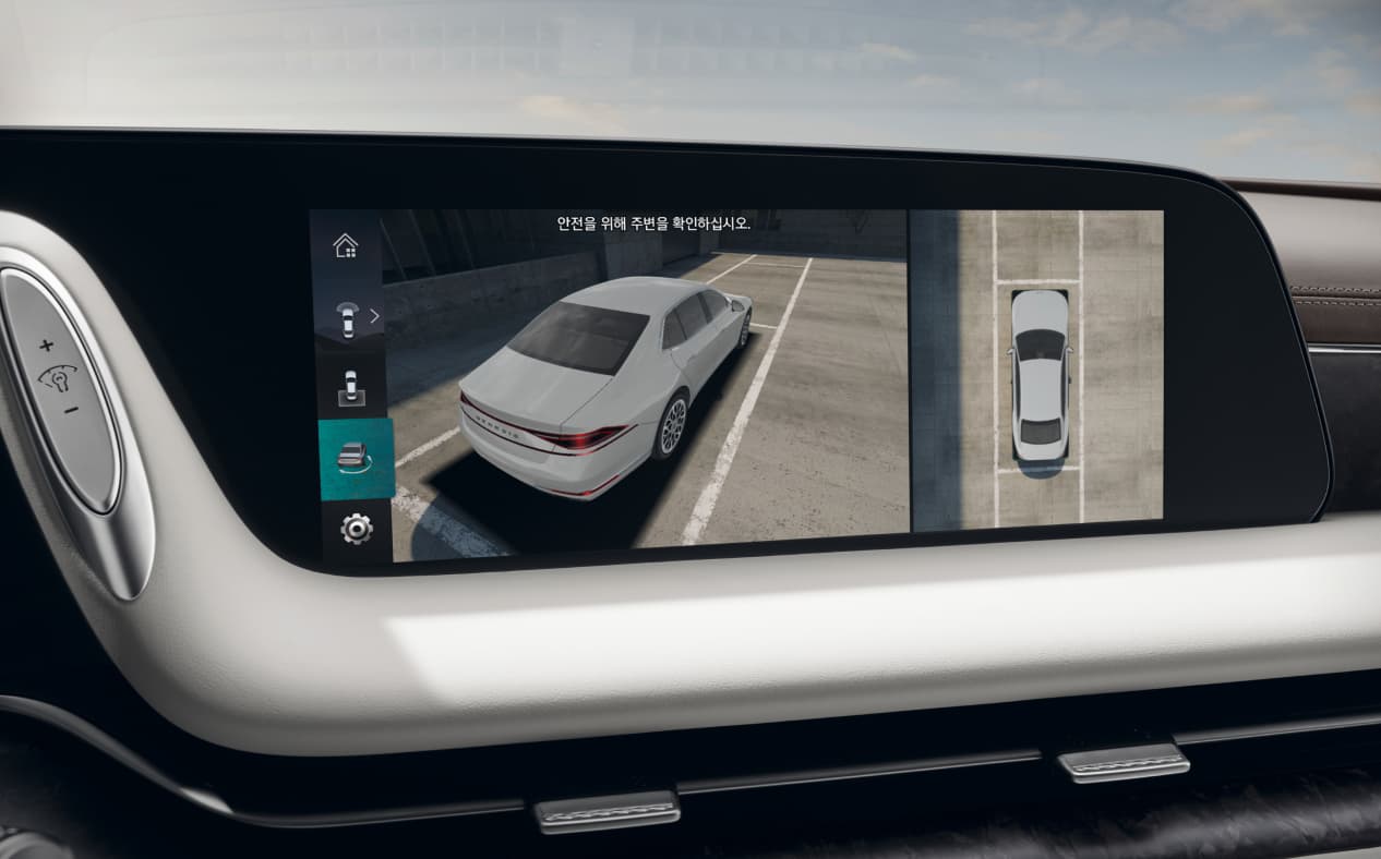 The area surrounding the vehicle is seen through the surround view monitor on the infotainment display in Glacier White interior.
