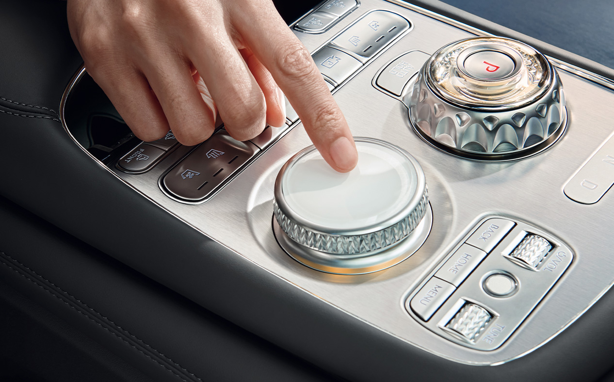 A hand operates the controller.