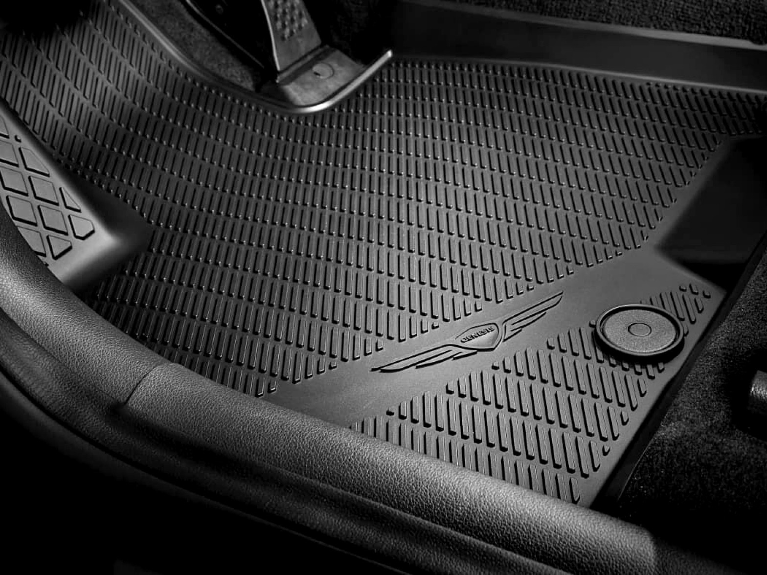 The black floor mat installed on the vehicle's interior floor is visible.