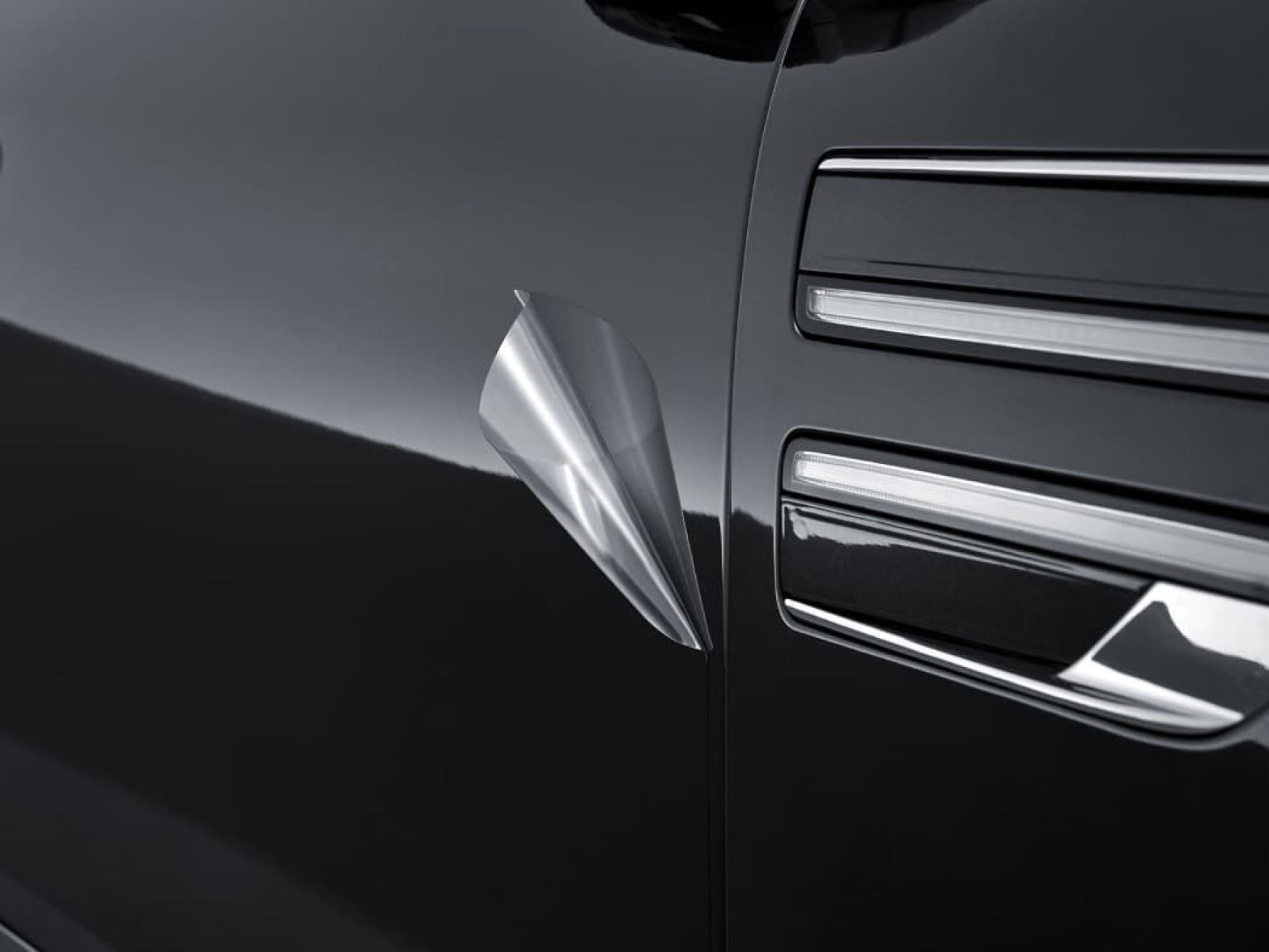 Next to the two-stripe design on the Genesis vehicle, a slightly peeling protective film is visible.