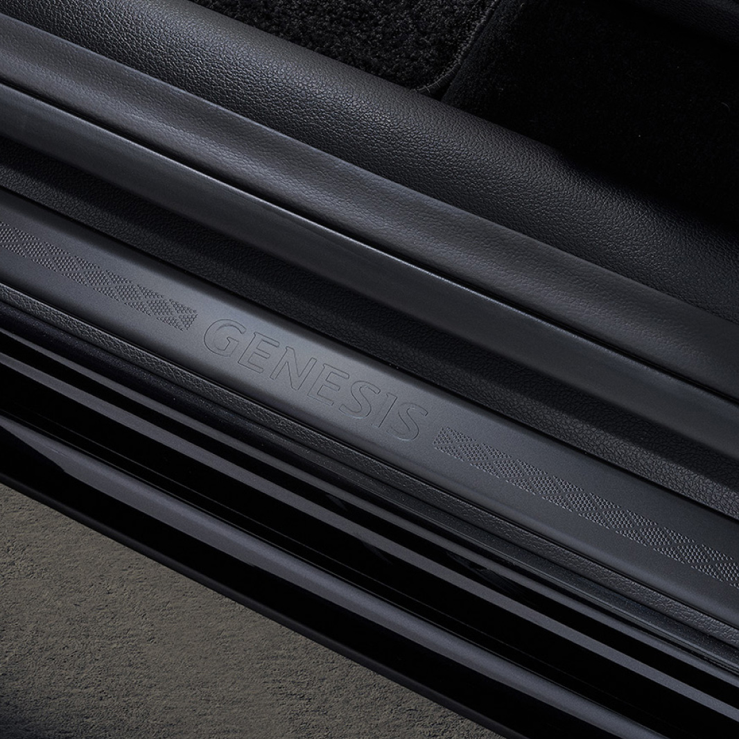A black door sill engraved with 'GENESIS' is shown.