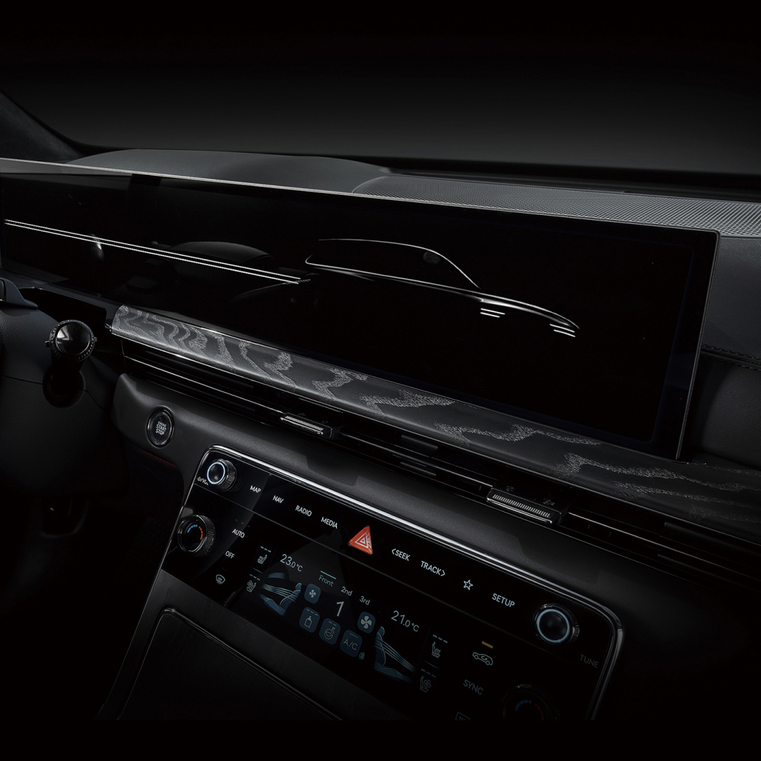 The center fascia, dominated by black, features a wide 27-inch display.