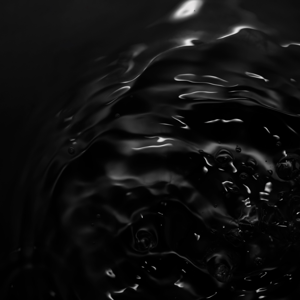 A wave of black liquid is visible.