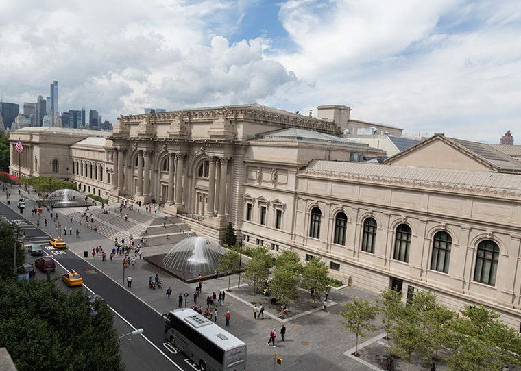 The view of The Metropolitan Museum of Art is visible, with a fountain and pedestrians in the plaza in front.