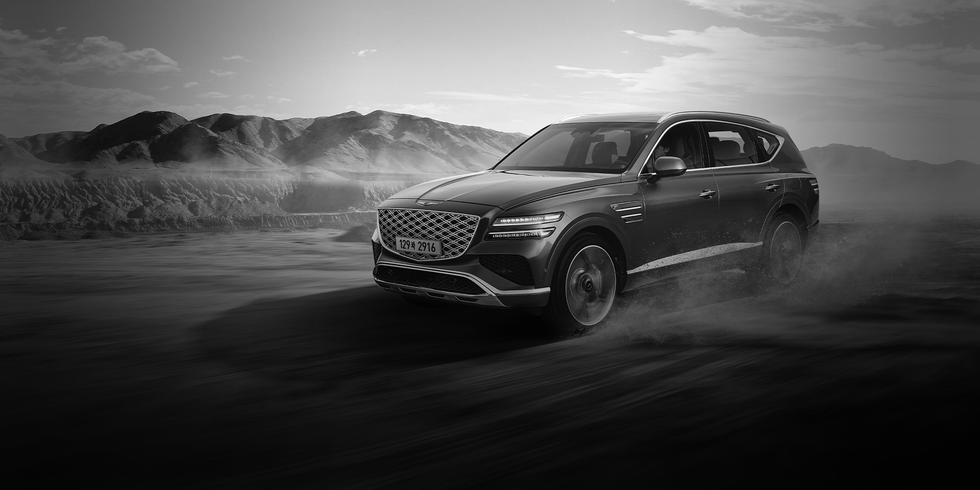 GV80 driving dynamically on the sand.
