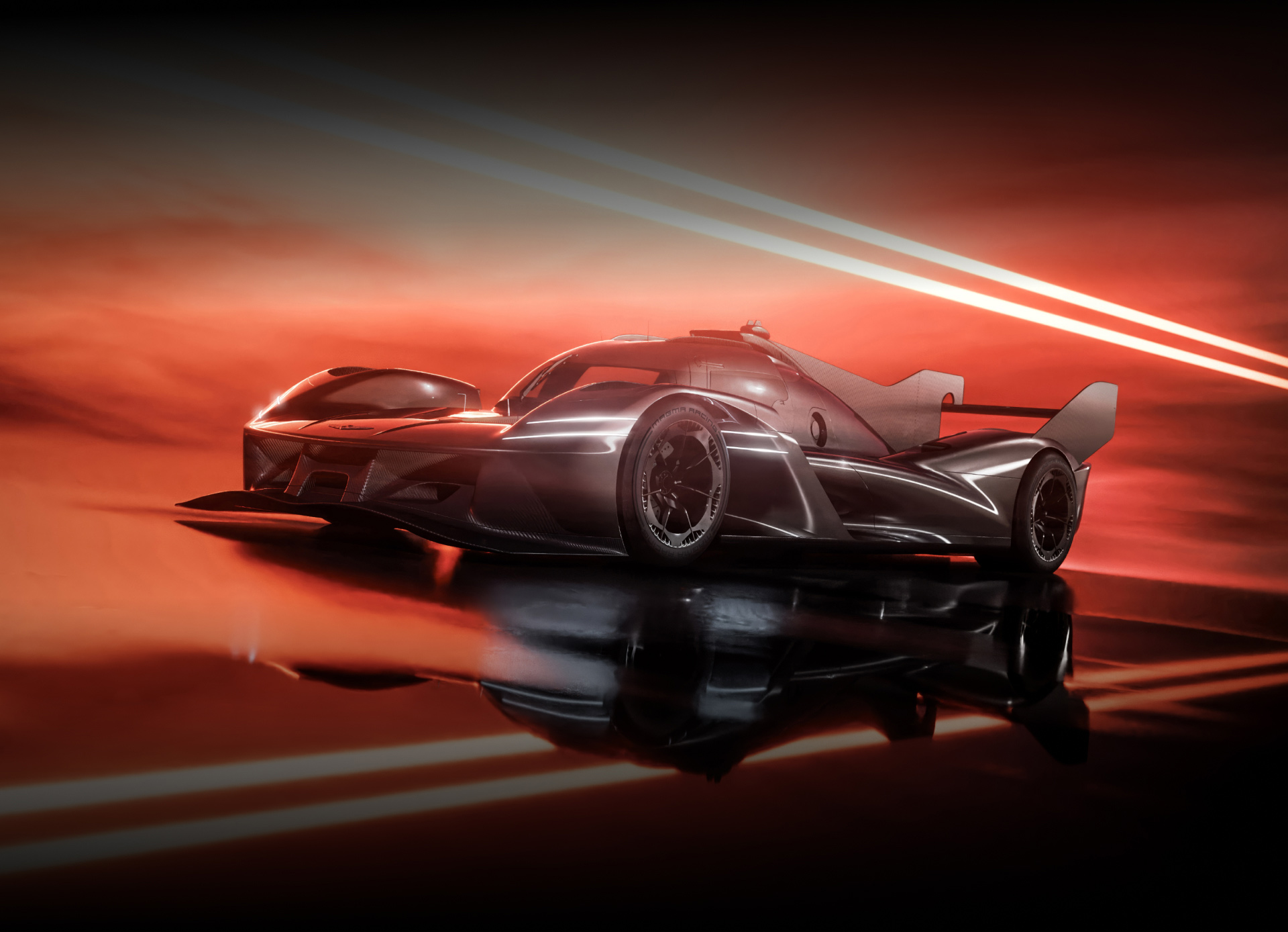 The GMR-001 Hypercar stands on a dark road, facing forward. 