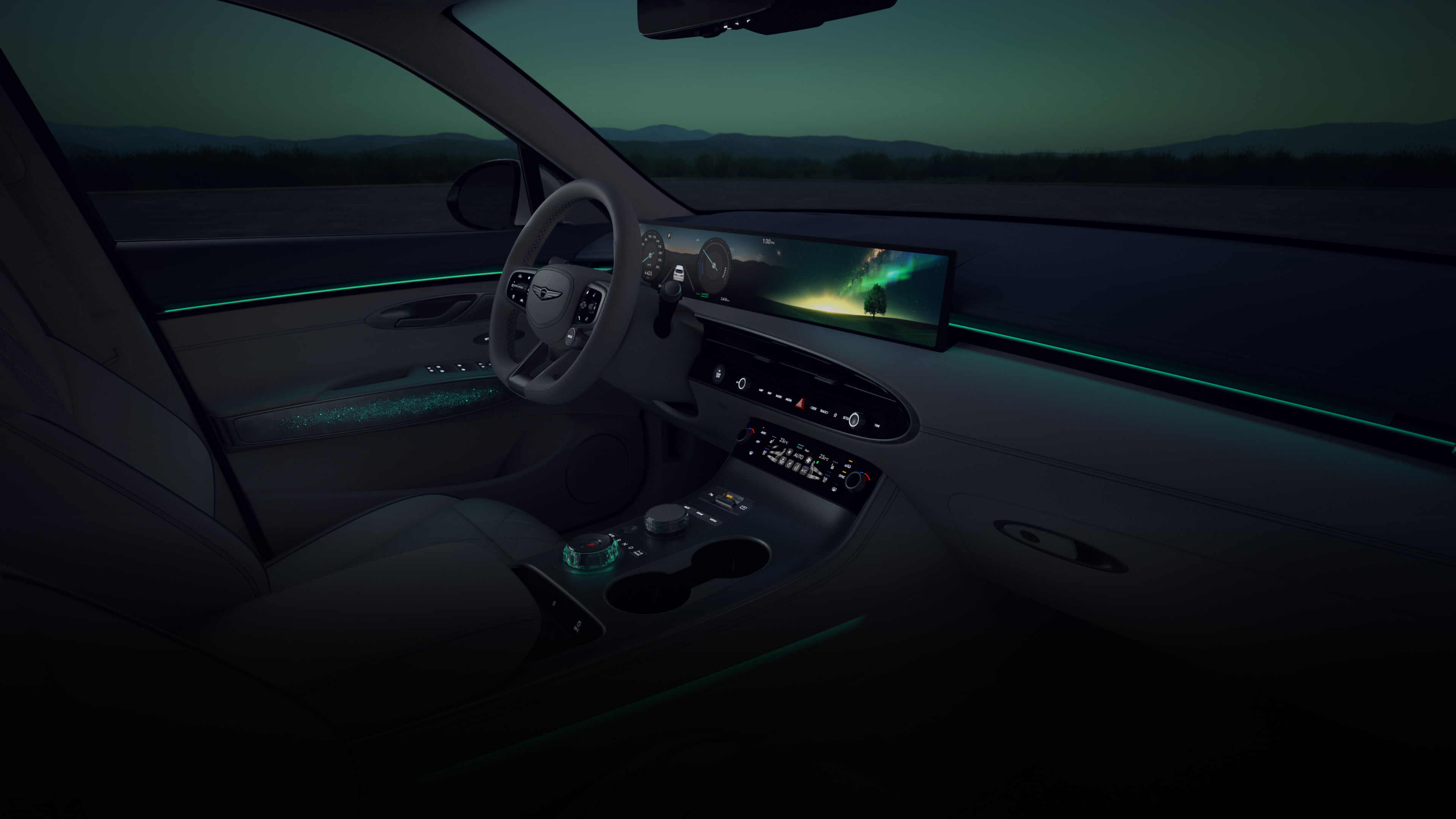 A wide-angle view of the driver's seat from the front passenger's seat. A vibrant array of colorful graphics cycle on the wide display screen in front of the driver’s seat. As the colors on the display shift, so does the ambient lighting of the vehicle's interior. 