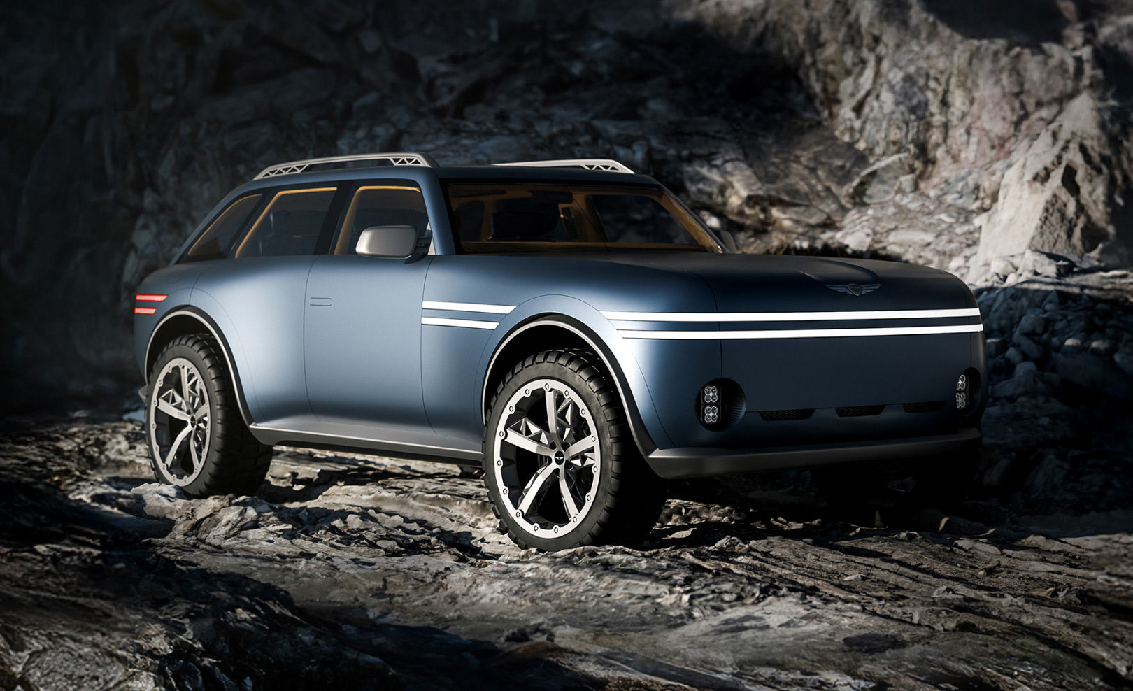 The Genesis X Gran Equator concept is parked on rocky terrain, with the front two-line lamps illuminated.