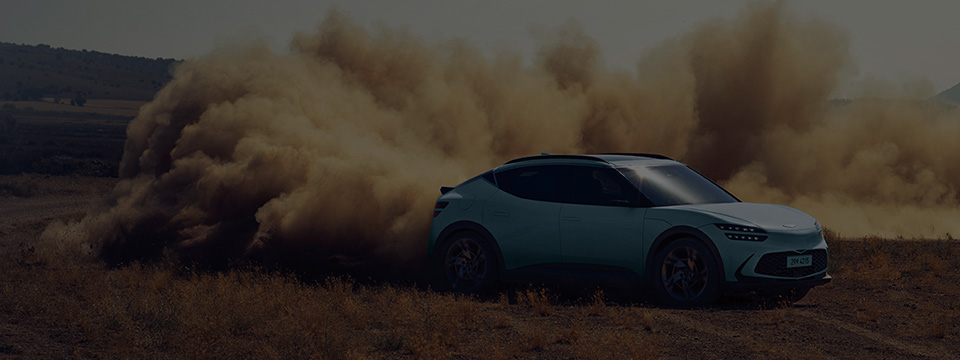The Hanauma mint-colored GV60 is driving dynamically with a sandstorm.