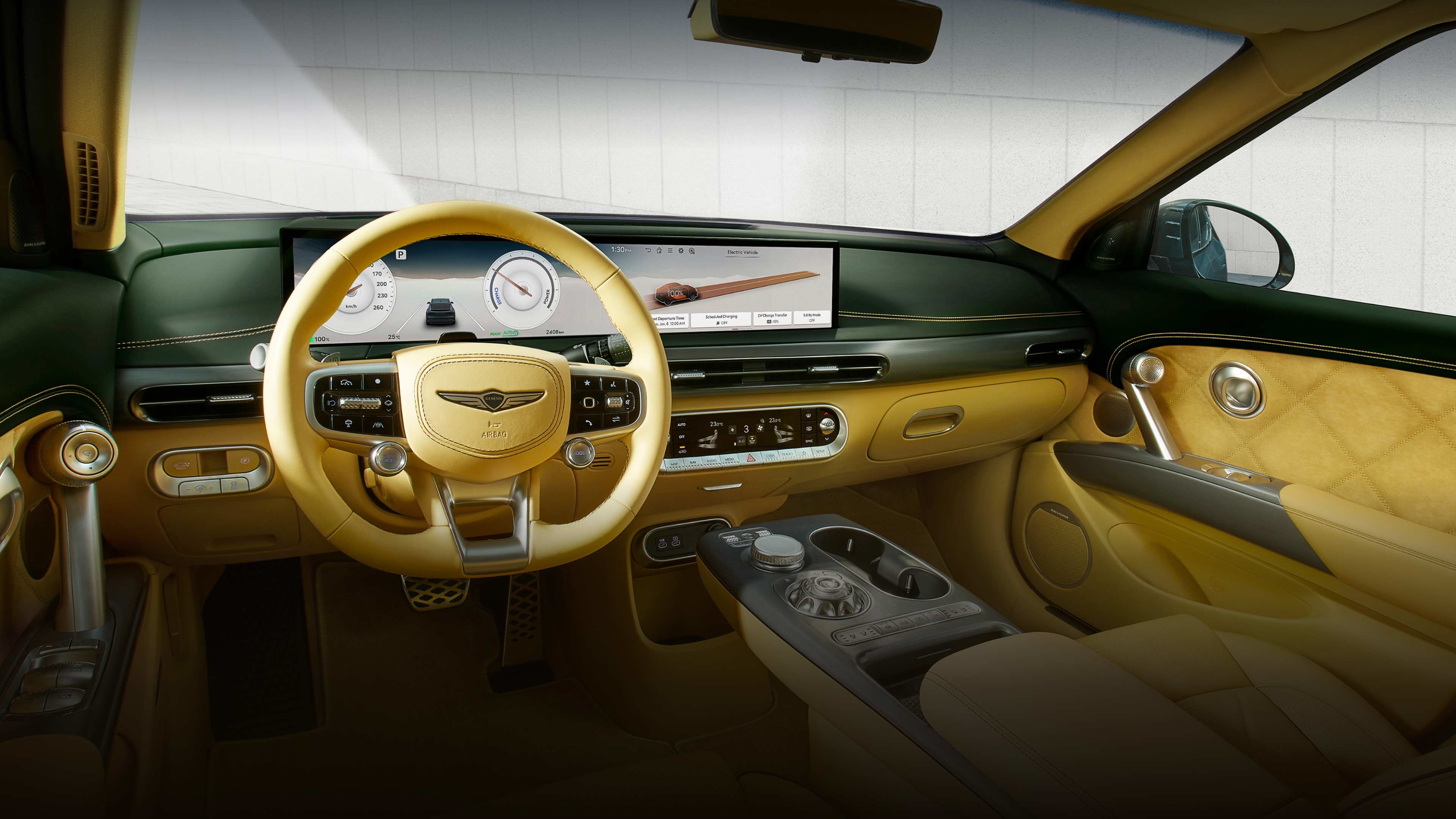  The interior of the front seat of the GV60 vehicle is visible, ranging from various functional buttons located near the vehicle door handle to the steering wheel or display and numerous control buttons located between the driver and passenger seats.