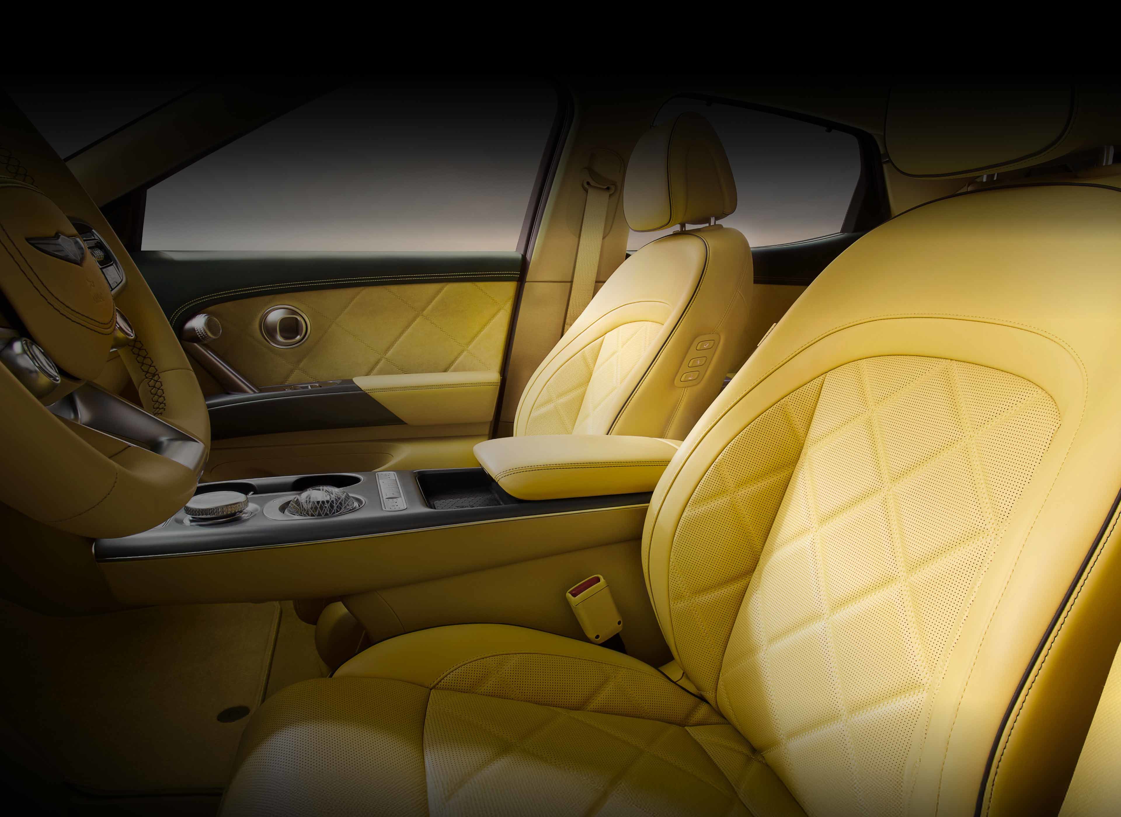 The interior of the front seat of the vehicle is visible. The texture of the yellow leather seats is highlighted.