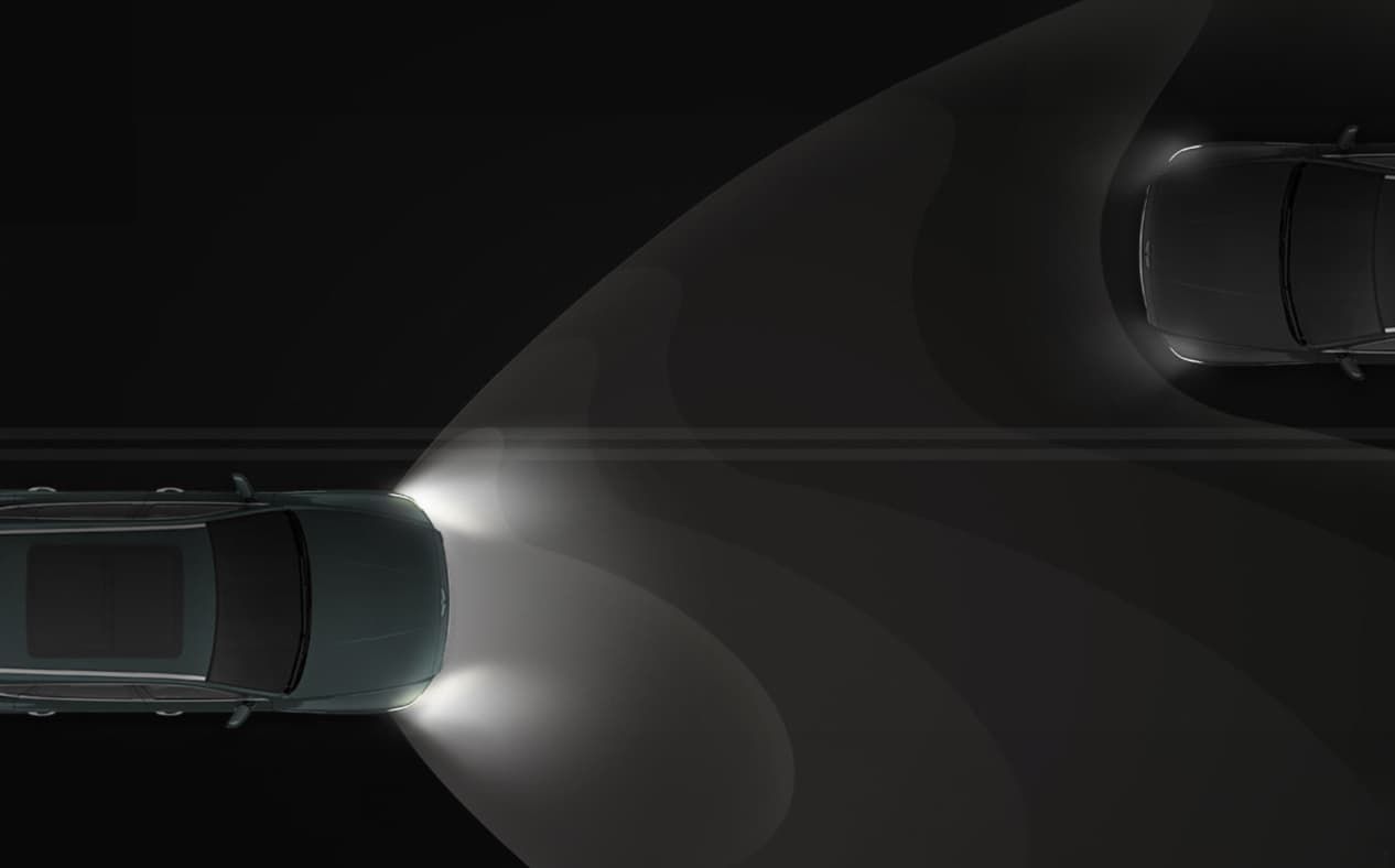 GV80 driving on a dark road with the headlamps turned on.